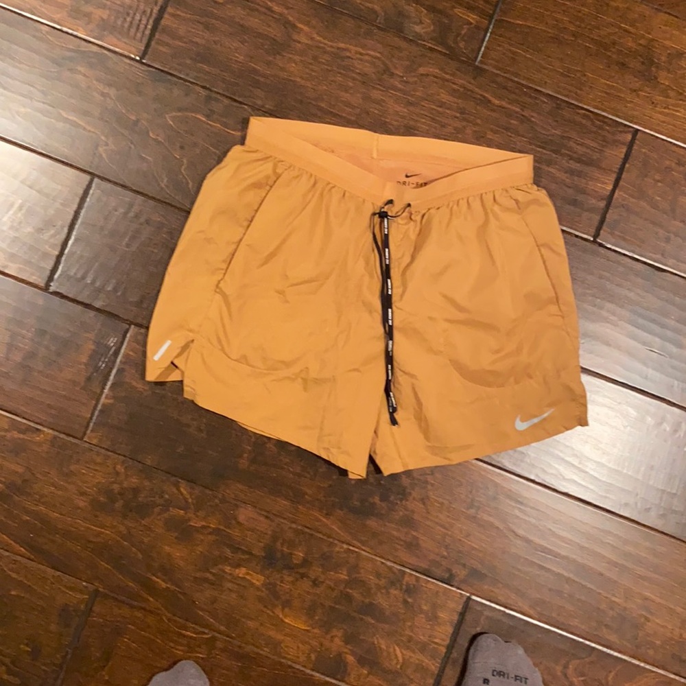 Tan Nike shorts with compression underneath size M